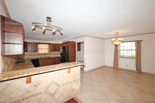5507 Harvard St, Amarillo, TX 79109 - kitchen with black appliances, a chandelier, a sink, tasteful backsplash, and open shelves