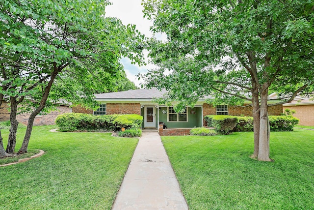 5507 Harvard St, Amarillo, TX 79109 - ranch-style house featuring a front yard and brick siding