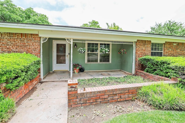 5507 Harvard St, Amarillo, TX 79109 - view of exterior entry featuring a porch and brick siding