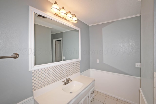 5507 Harvard St, Amarillo, TX 79109 - bathroom with vanity, crown molding, backsplash, and tile patterned floors