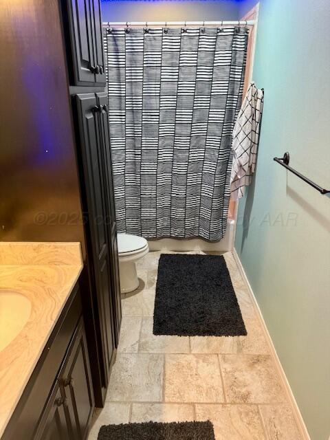4301 Fairway Dr, Amarillo, TX 79124 - bathroom with vanity, toilet, shower / bathtub combination with curtain, and baseboards