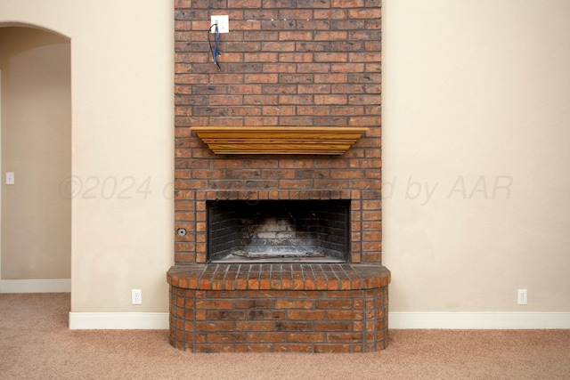 details with carpet floors and a brick fireplace