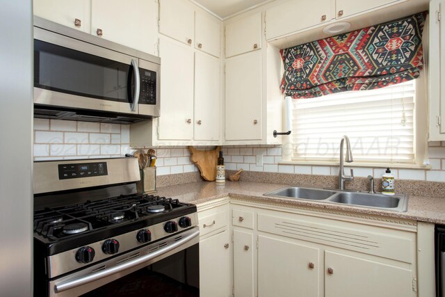 3412 Lenwood Dr, Amarillo, TX 79109 - kitchen with appliances with stainless steel finishes, light countertops, decorative backsplash, and white cabinetry