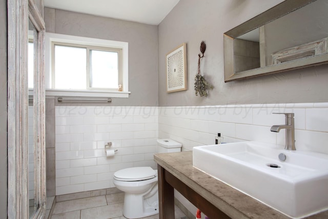 3412 Lenwood Dr, Amarillo, TX 79109 - bathroom with tile walls, vanity, a stall shower, a wainscoted wall, and tile patterned flooring