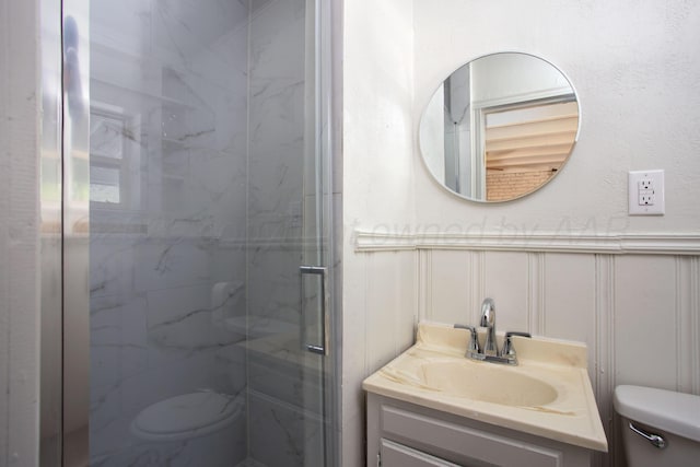 3412 Lenwood Dr, Amarillo, TX 79109 - bathroom featuring a marble finish shower, a decorative wall, vanity, and wainscoting