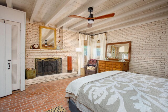 3412 Lenwood Dr, Amarillo, TX 79109 - bedroom with brick flooring, brick wall, a fireplace, a wooden ceiling with exposed beams, and a ceiling fan