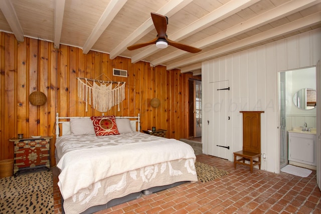 3412 Lenwood Dr, Amarillo, TX 79109 - bedroom featuring beam ceiling, wood walls, ensuite bath, brick flooring, and a ceiling fan