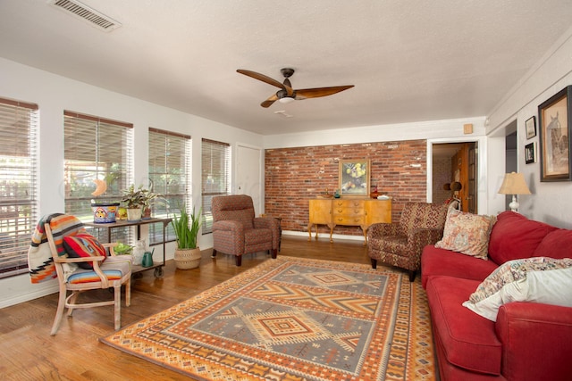 3412 Lenwood Dr, Amarillo, TX 79109 - living area with a ceiling fan, wood finished floors, and brick wall