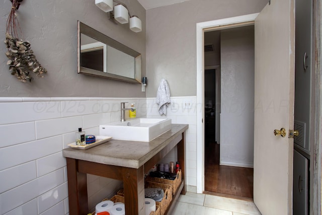 3412 Lenwood Dr, Amarillo, TX 79109 - bathroom featuring tile walls, a wainscoted wall, vanity, and tile patterned flooring