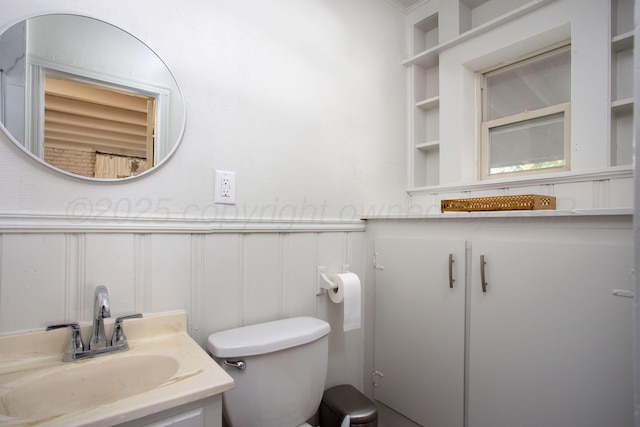 3412 Lenwood Dr, Amarillo, TX 79109 - bathroom with a decorative wall, vanity, and wainscoting