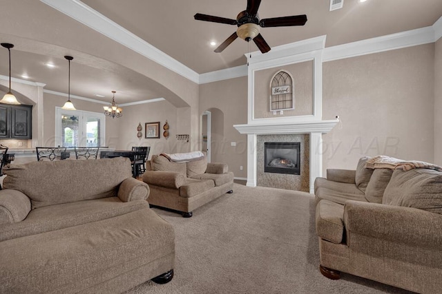 8313 Irvington Ct, Amarillo, TX 79119 - living room with arched walkways, crown molding, a ceiling fan, a tiled fireplace, and recessed lighting