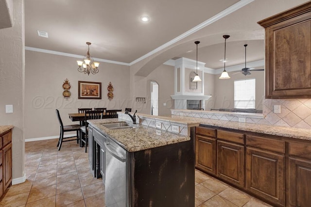 8313 Irvington Ct, Amarillo, TX 79119 - kitchen with dishwasher, arched walkways, a sink, backsplash, and baseboards