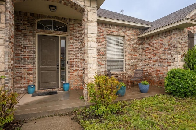 8313 Irvington Ct, Amarillo, TX 79119 - view of exterior entry with brick siding and roof with shingles
