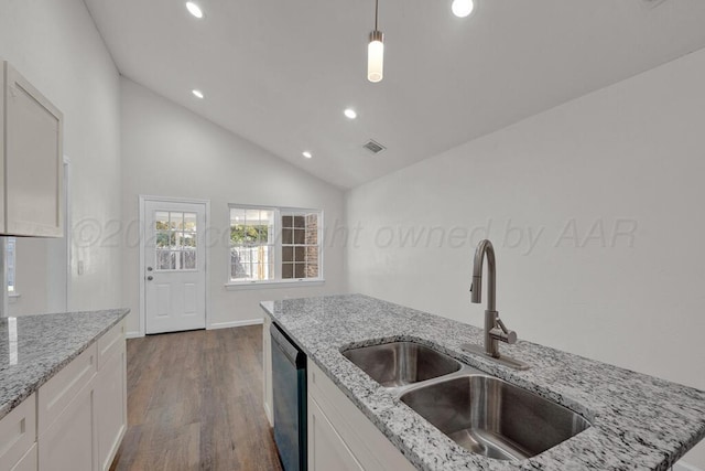 4204 Roxton Dr, Amarillo, TX 79109 - kitchen with dishwashing machine, recessed lighting, lofted ceiling, dark wood-type flooring, and white cabinets