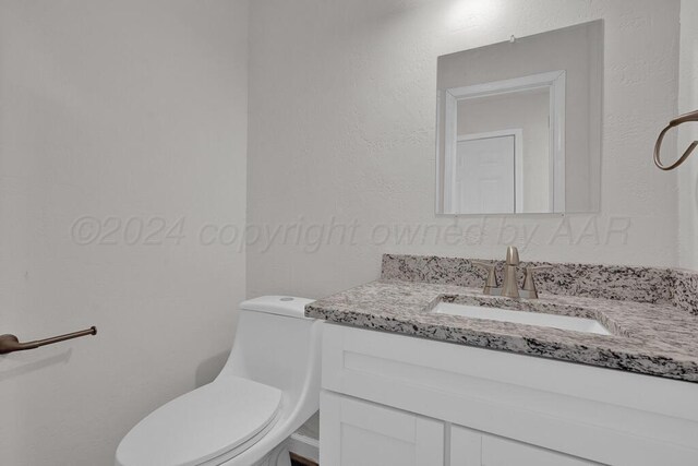 4204 Roxton Dr, Amarillo, TX 79109 - half bathroom with vanity and a textured wall