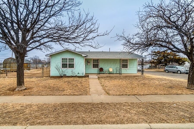 view of front facade with a porch and fence