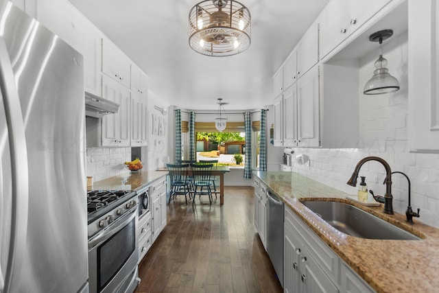 kitchen featuring pendant lighting, white cabinets, sink, and stainless steel appliances