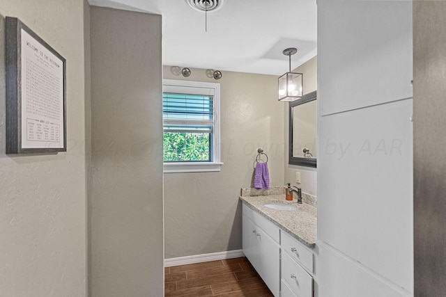 bathroom with hardwood / wood-style flooring and vanity