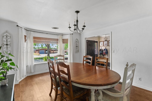 dining space with a notable chandelier and hardwood / wood-style flooring