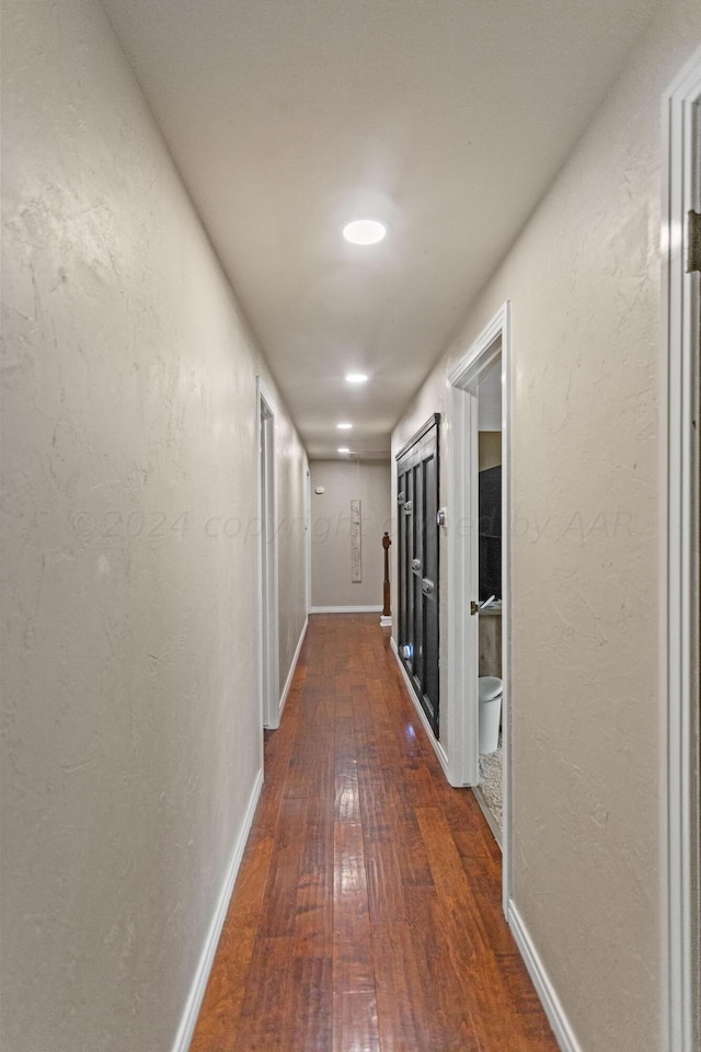 hall with dark wood-type flooring