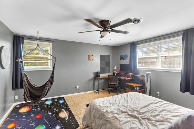 bedroom featuring carpet, multiple windows, and ceiling fan