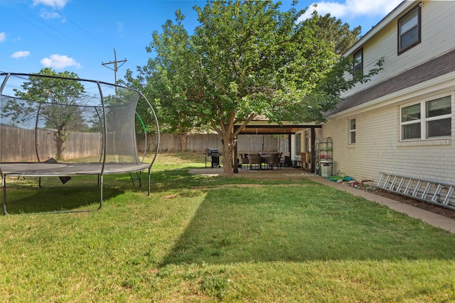 view of yard featuring a patio and a trampoline