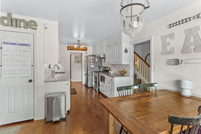 dining space with dark wood-type flooring and sink