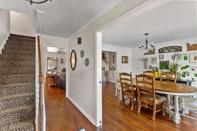 dining area with ornamental molding, dark hardwood / wood-style flooring, and a notable chandelier