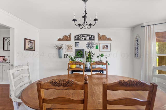 dining space with hardwood / wood-style floors, a notable chandelier, and ornamental molding