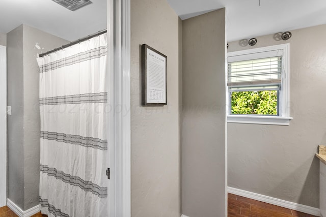 bathroom with a shower with curtain, hardwood / wood-style flooring, and vanity