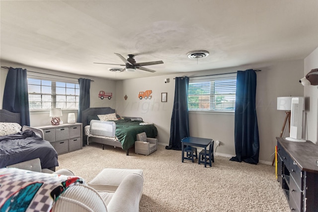 bedroom with ceiling fan and light colored carpet