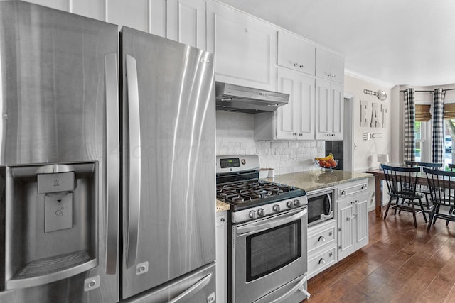 kitchen with stainless steel appliances, white cabinetry, light stone counters, range hood, and dark hardwood / wood-style flooring