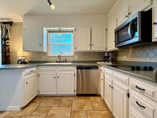 kitchen featuring white cabinetry, ornamental molding, appliances with stainless steel finishes, and sink