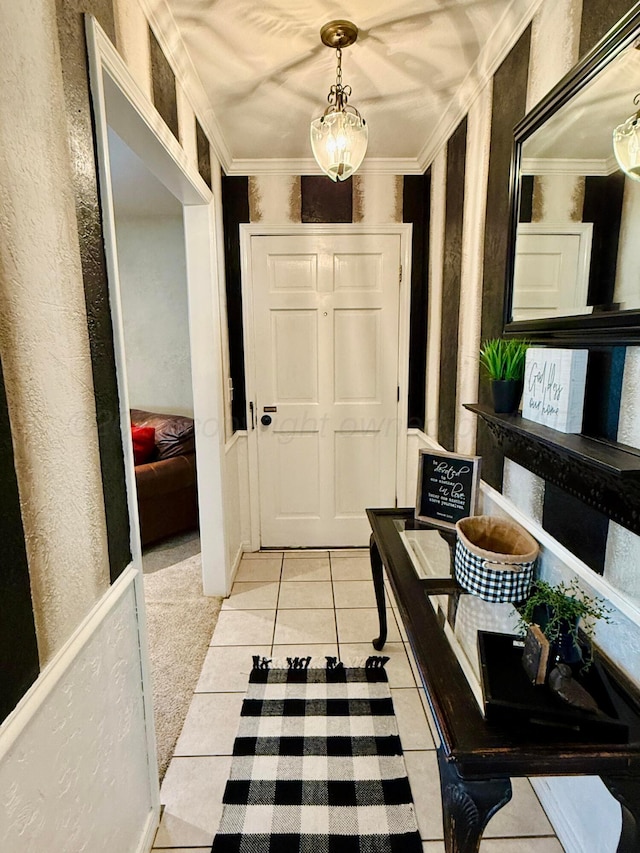 interior space with crown molding and light tile patterned floors