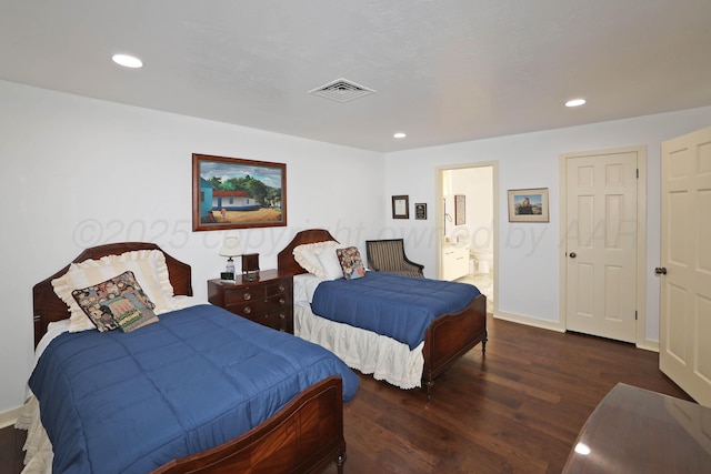 bedroom featuring dark hardwood / wood-style flooring and connected bathroom