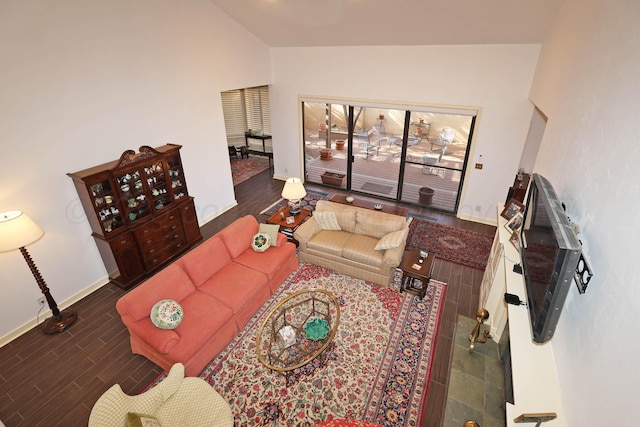 living room with lofted ceiling and dark wood-type flooring