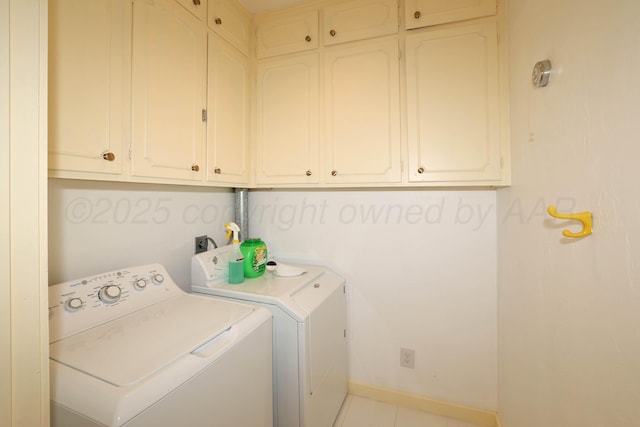 laundry room with independent washer and dryer, cabinets, and light tile patterned flooring