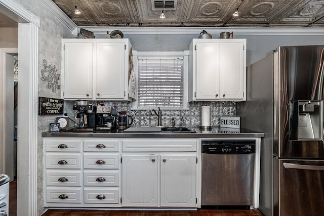 kitchen featuring an ornate ceiling, stainless steel appliances, a sink, and white cabinetry