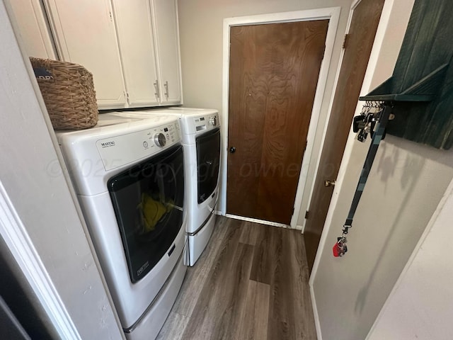 313 Mustang St, Fritch, TX 79036 - laundry room featuring washer and dryer, dark wood-style floors, and cabinet space