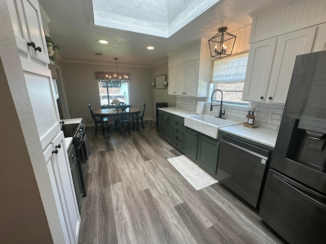 313 Mustang St, Fritch, TX 79036 - kitchen with a chandelier, stainless steel appliances, ornamental molding, decorative backsplash, and light countertops