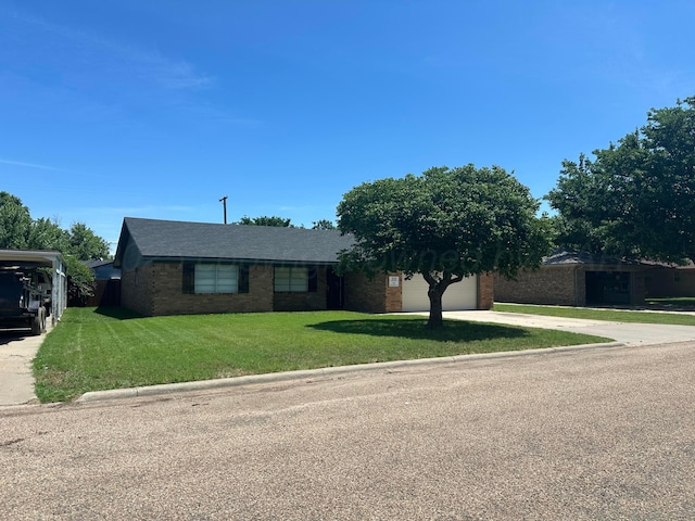 313 Mustang St, Fritch, TX 79036 - view of front of house with driveway, brick siding, a front lawn, and a garage