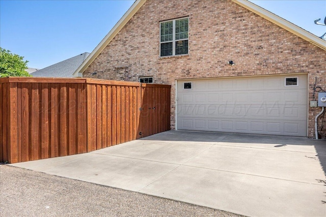 7808 Pineridge Dr, Amarillo, TX 79119 - view of side of home with brick siding, concrete driveway, and a garage
