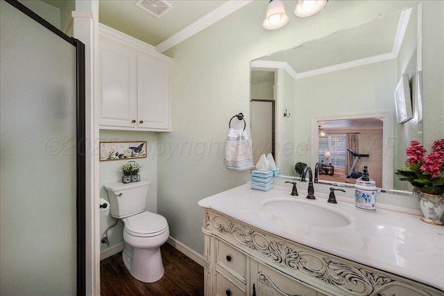 7808 Pineridge Dr, Amarillo, TX 79119 - bathroom with ornamental molding, vanity, a stall shower, toilet, and wood finished floors