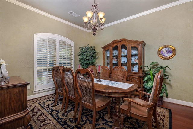 7808 Pineridge Dr, Amarillo, TX 79119 - dining room with a chandelier, baseboards, wood finished floors, and crown molding