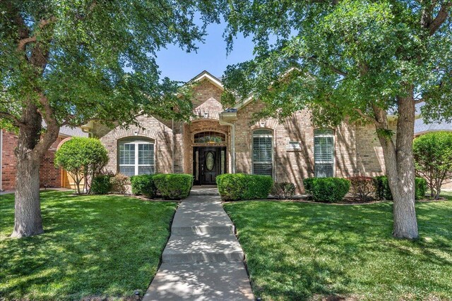 7808 Pineridge Dr, Amarillo, TX 79119 - view of front facade with brick siding and a front yard