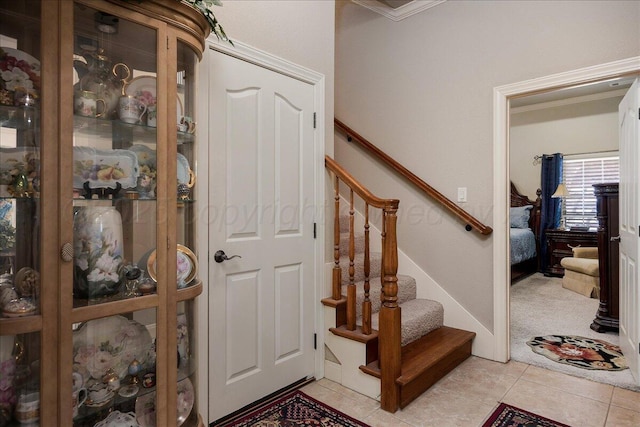 7808 Pineridge Dr, Amarillo, TX 79119 - foyer entrance with light tile patterned flooring, stairway, ornamental molding, and light carpet