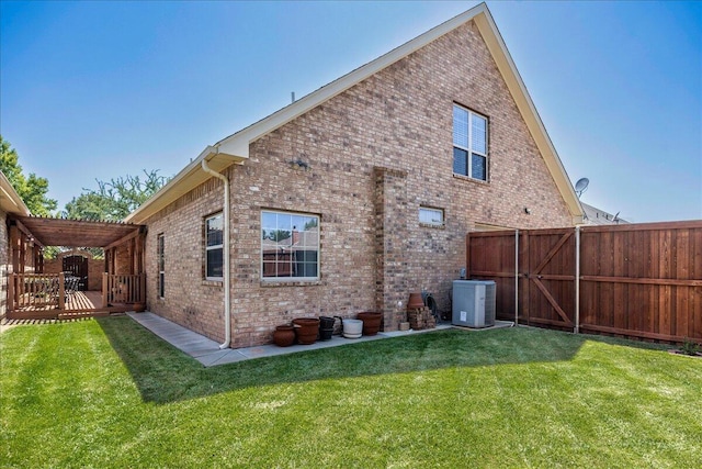 7808 Pineridge Dr, Amarillo, TX 79119 - rear view of house featuring brick siding, central AC unit, a wooden deck, and a gate
