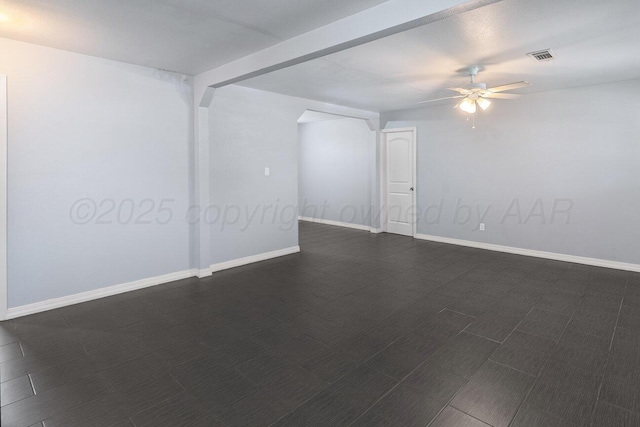 3804 NE 26th Ave, Amarillo, TX 79107 - empty room featuring a ceiling fan, arched walkways, and baseboards