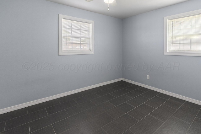 3804 NE 26th Ave, Amarillo, TX 79107 - empty room featuring baseboards, a ceiling fan, and dark tile patterned flooring