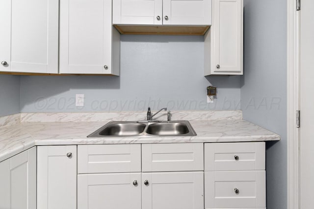 3804 NE 26th Ave, Amarillo, TX 79107 - kitchen featuring a sink, white cabinets, and light countertops